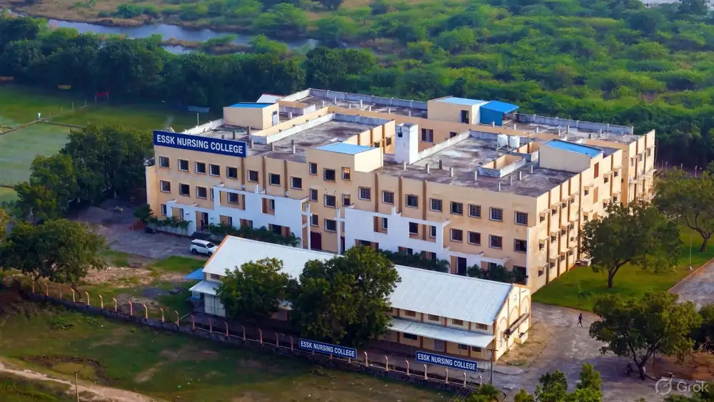 Aerial view of the campus: a large building and a smaller hall with ESSK Nursing College signs, surrounded by trees and fields