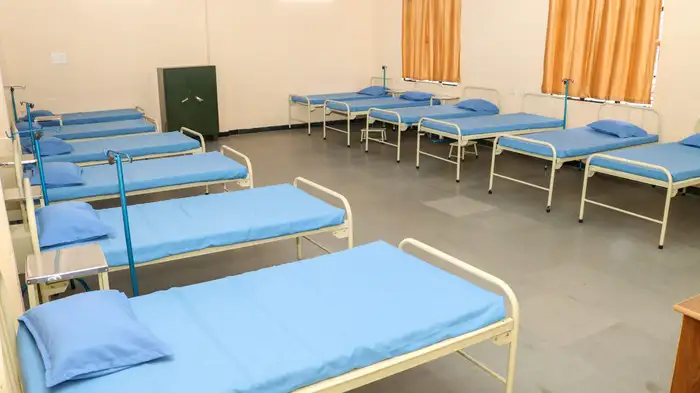 A large ward with rows of hospital beds